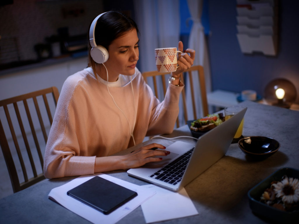 Woman with headphones working from home